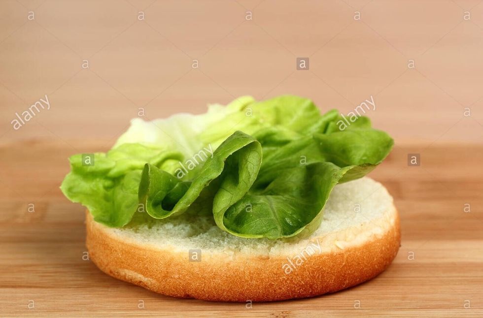 Lay lettuce over the base of each bun.