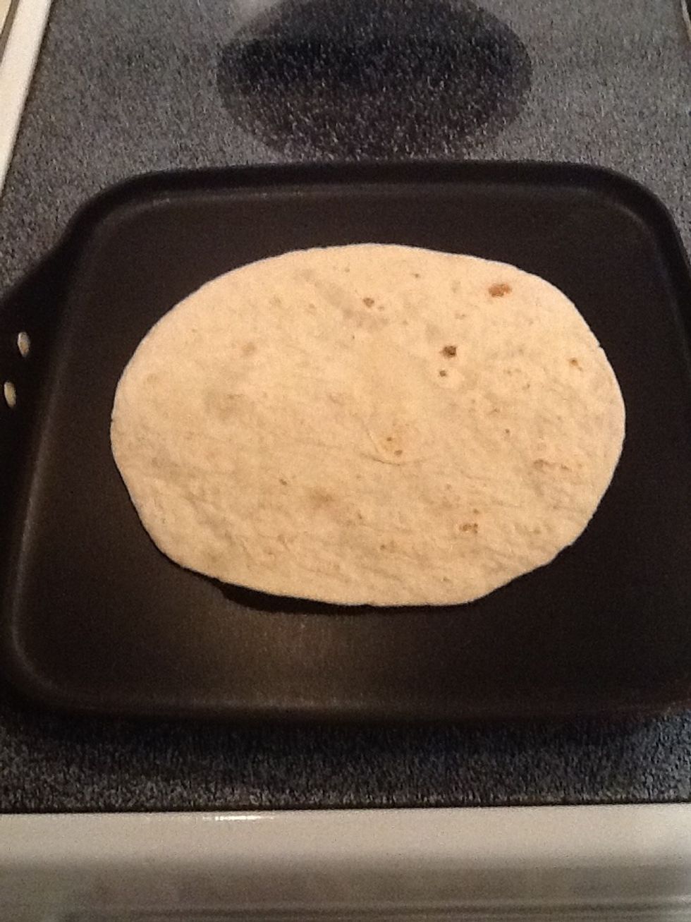 Lay one soft taco shell on a heated pan or griddle set to medium heat. No oil or butter needed.