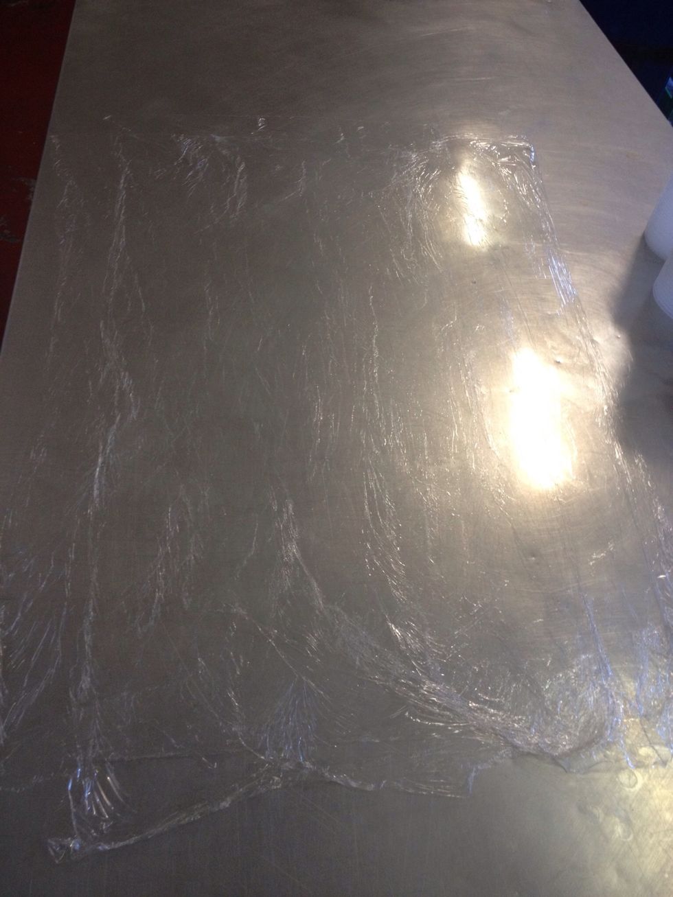 Lay out 3 sheets of cling film and smooth out