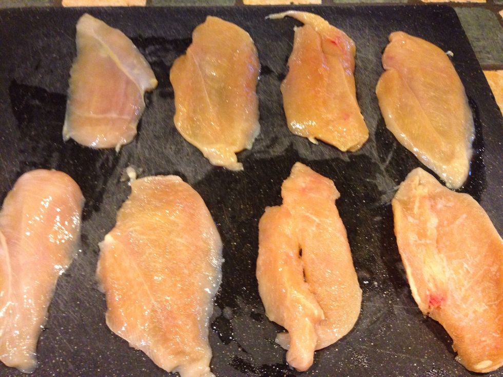 Lay out chicken breast on a large cutting bored