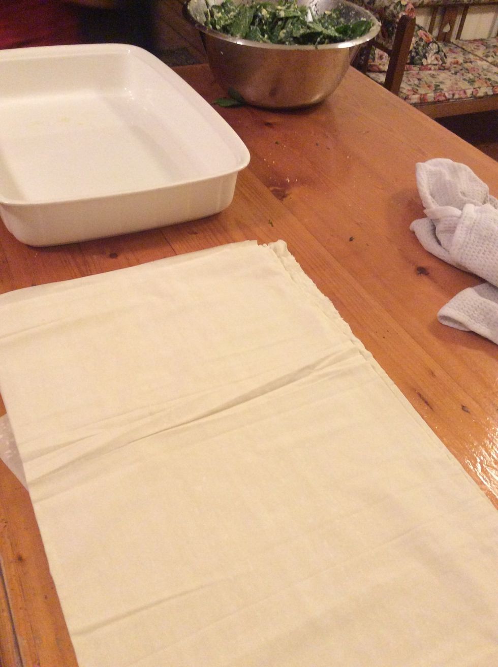 Lay out filo pastry on a bench or your kitchen space and have a damp towel to cover when layering so the pastry doesn't dry out.