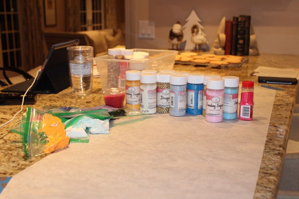 Lay out parchment paper on the surface you will be icing on and pick out some decorations