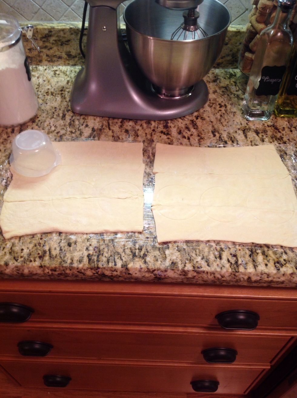 Lay out puff pastry and use cup/small bowl to cut out small circles