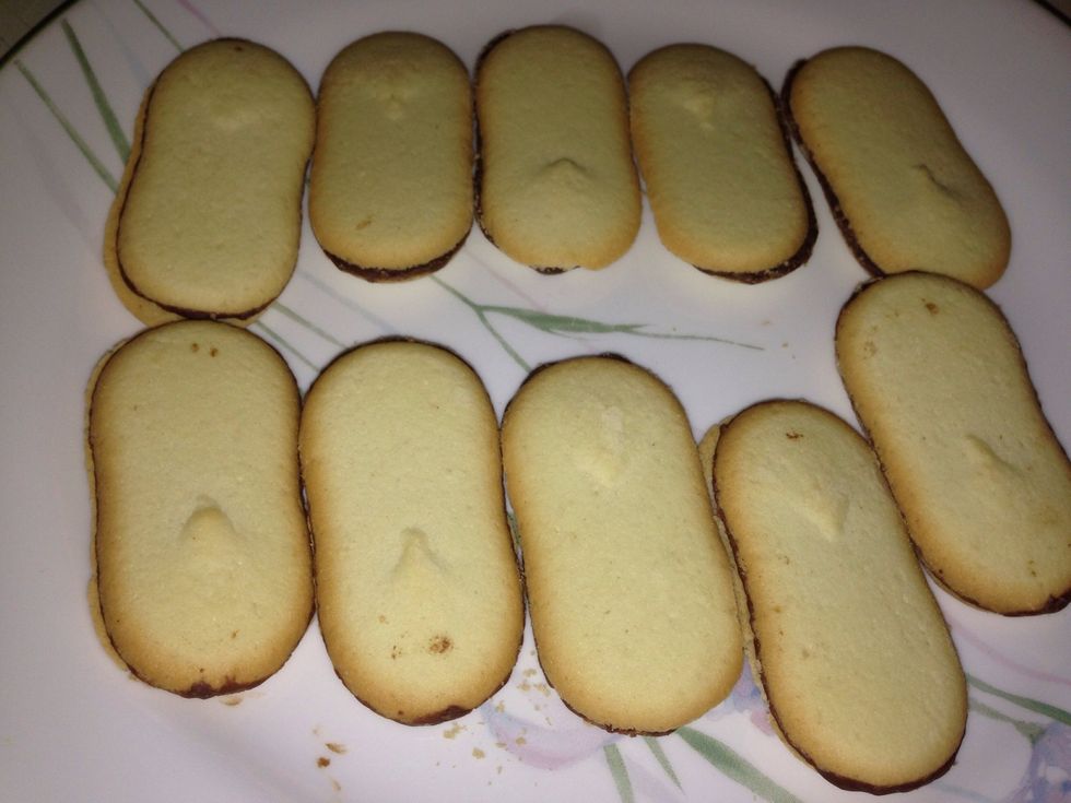 Lay out some Milano cookies on a plate.