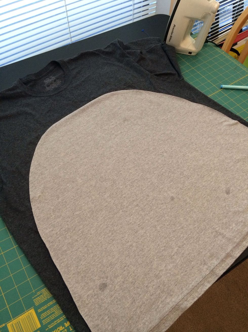 Lay out the cut belly piece on top of the front of your dark grey shirt to make sure it is even and looks right. Make adjustments as needed.