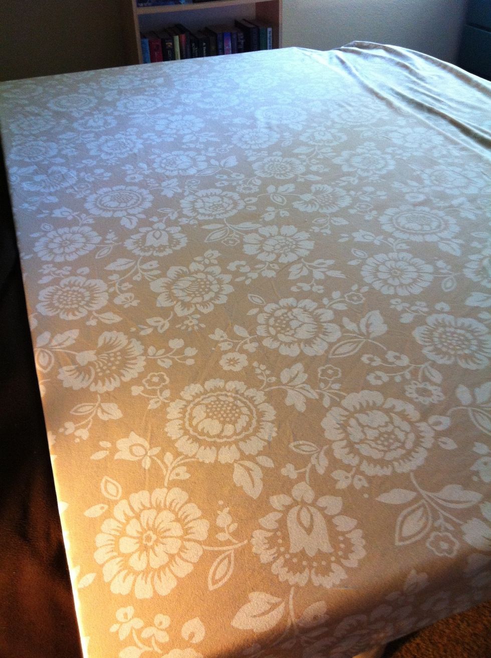 Lay out the fabric on top of the board however you think looks best. Since mine is a pattern, I wanted it to be straight.