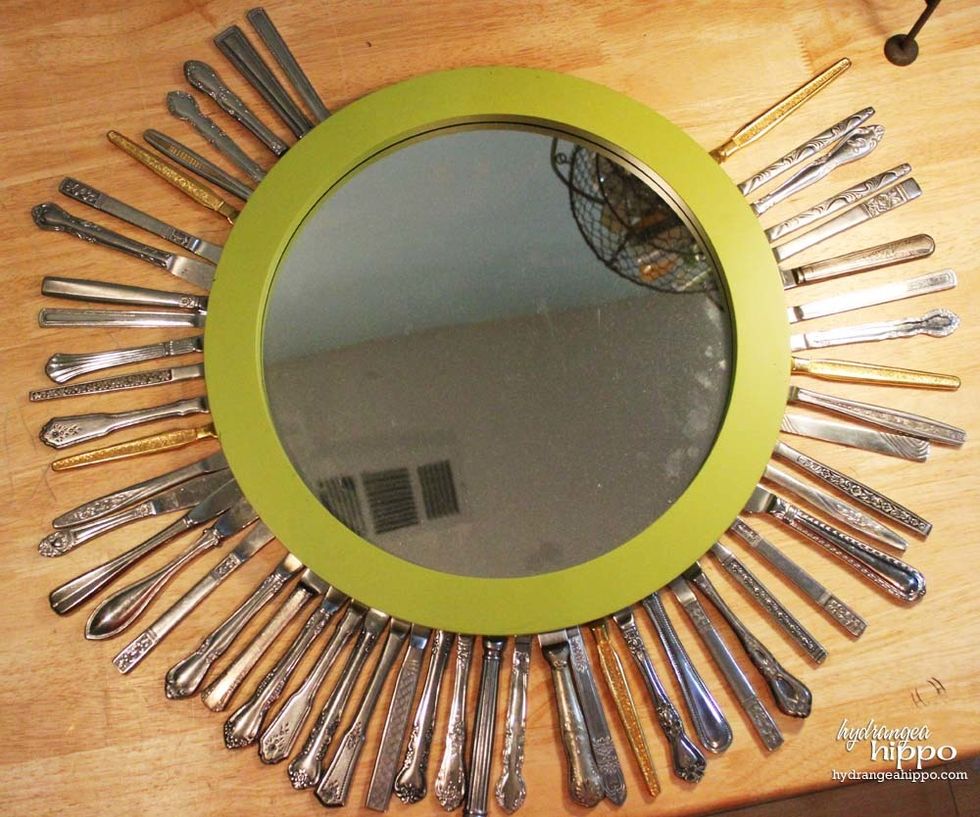 Lay out the knives in a pattern around the mirror. Make sure to vary the patterns and the long and short handles.