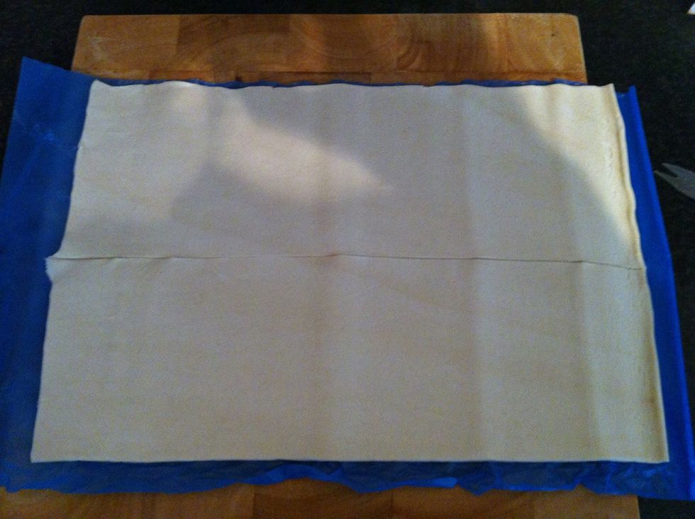 Lay out the puff pastry sheet and cut length ways