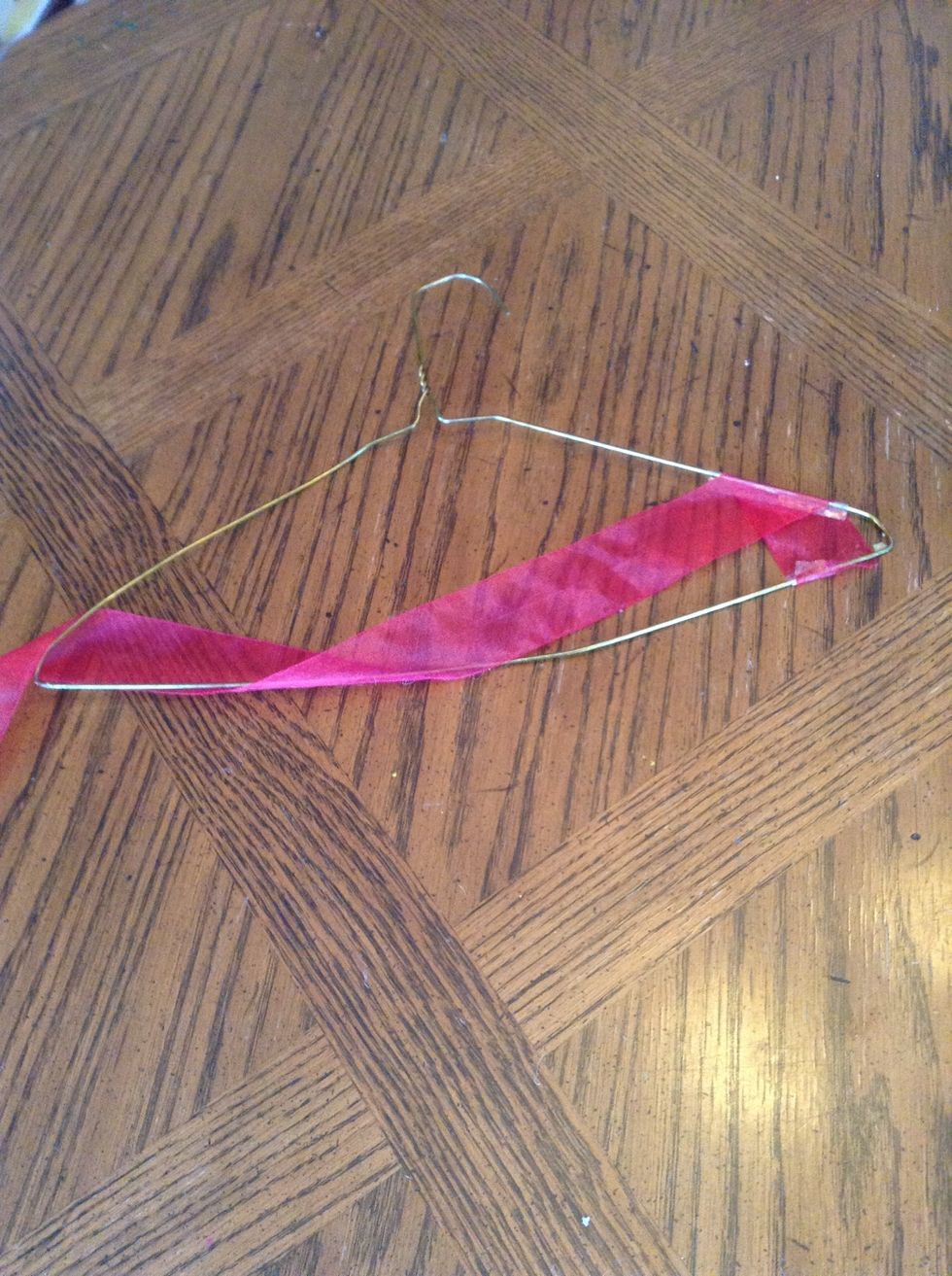 Lay out the ribbon onto the coat hanger any way you desire.