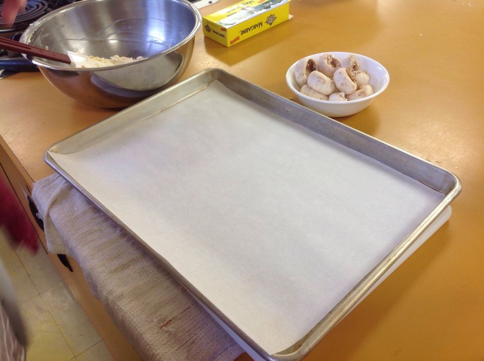 Lay out the sheet tray with a fitted piece of parchment paper. Have your mushroom caps and the filling ready.