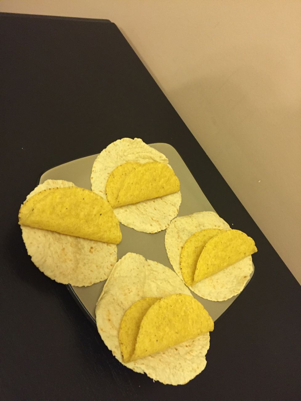Lay out the taco shells on a plate.