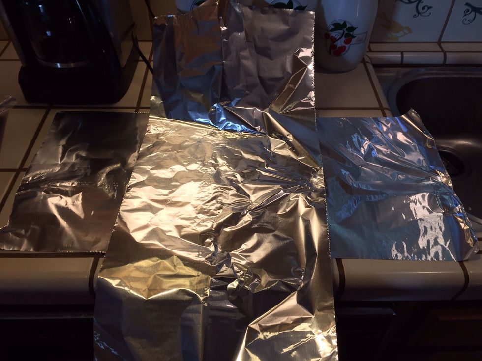Lay out two long pieces of foil, crosswise, set bread in middle.