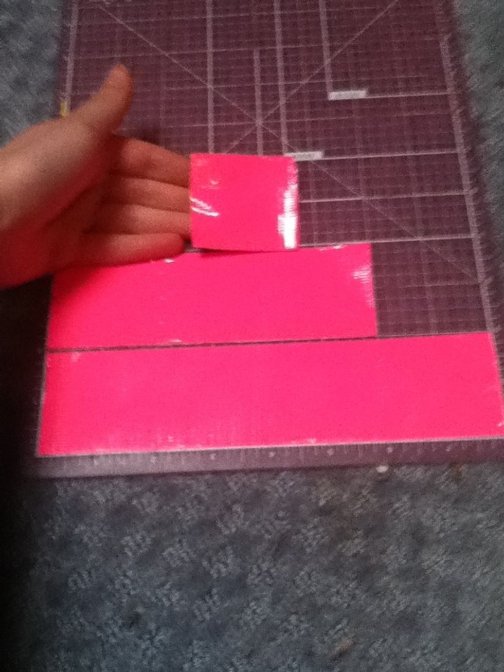 Lay out two strips of one color and cut them into two in pieces