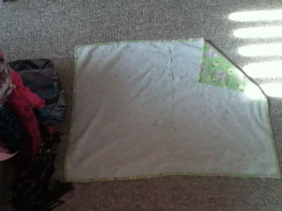 Lay out your blanket and fold the upper right corner.