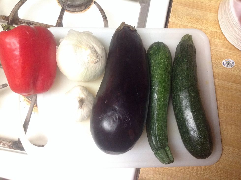 lay out your ingredients! wash and start cutting away! I used a garlic masher on the garlic to really get the flavor. The zucchini was quartered, the eggplant cubed, and pepper and onion diced small