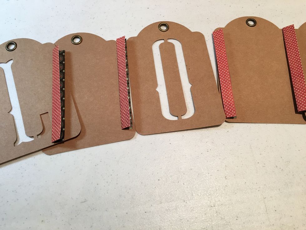 Lay out your tags and "LOVE" tags into the order you would like them to be and use double sided tape or liquid adhesive on the hinges to attach the tags together to form an album.