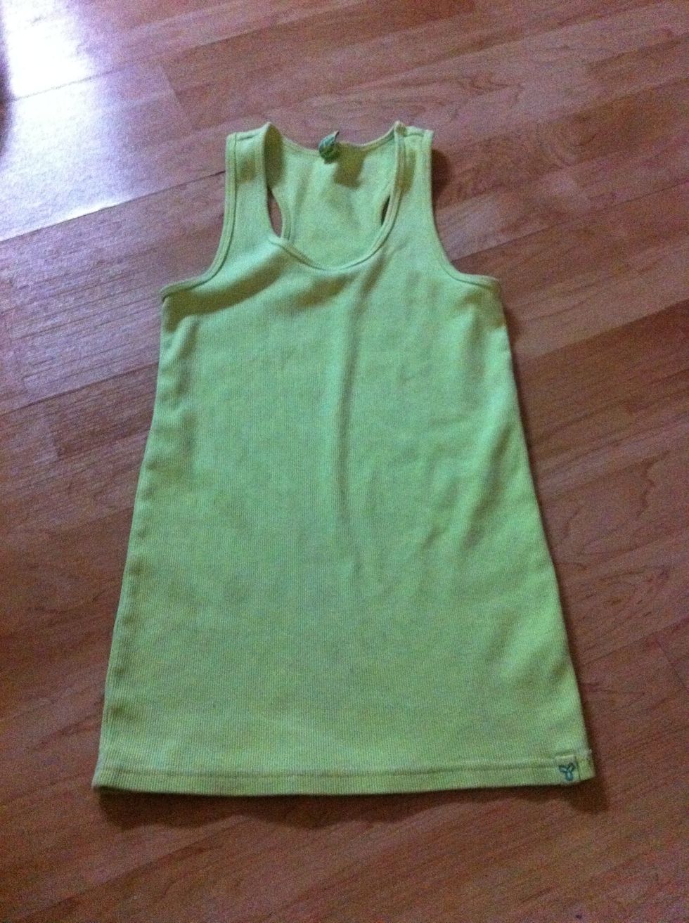 Lay out your tank top on your floor, bed, sofa, counter.....