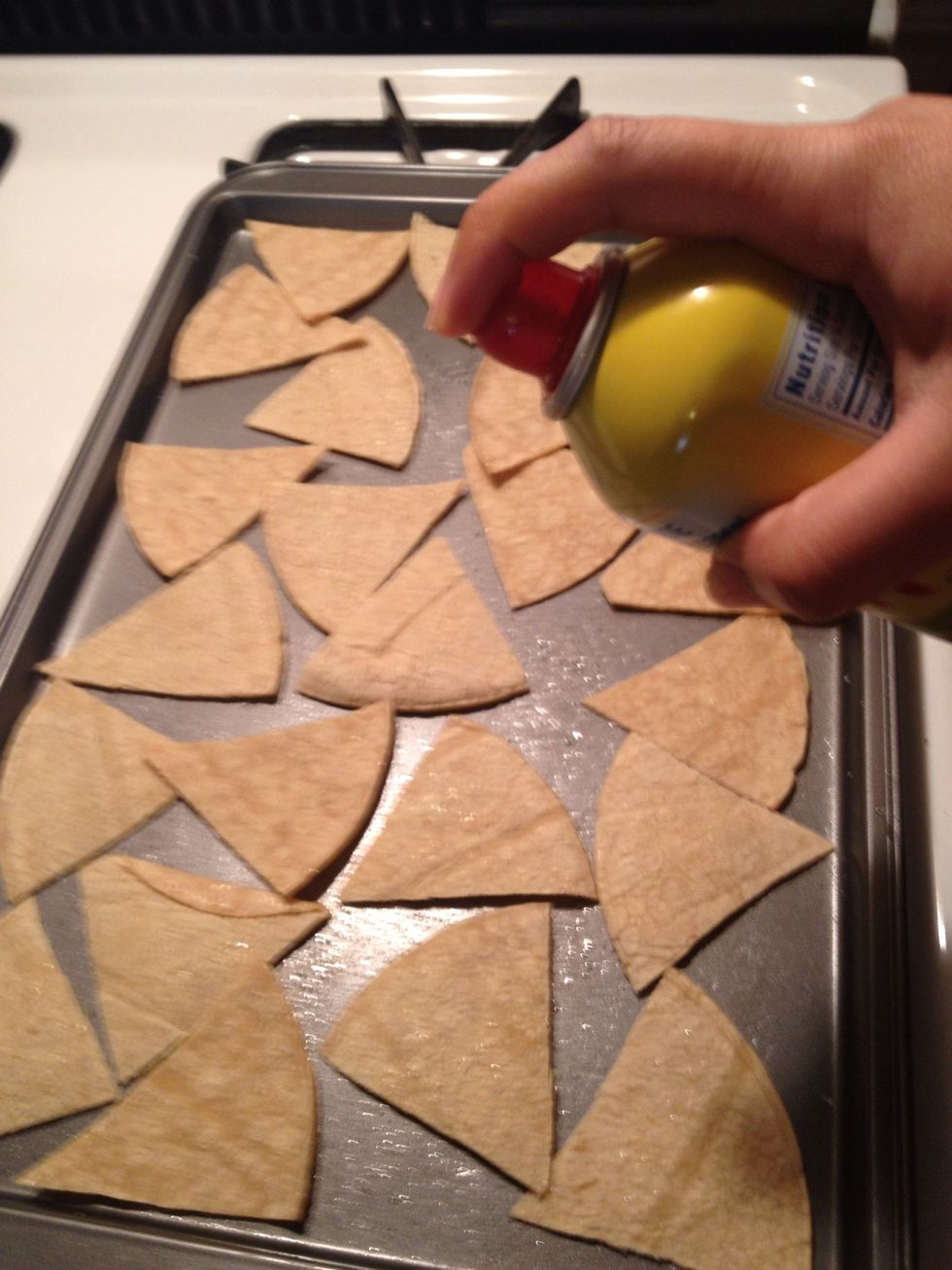 Lay pieces on cookie sheet and spray lightly with cooking spray.