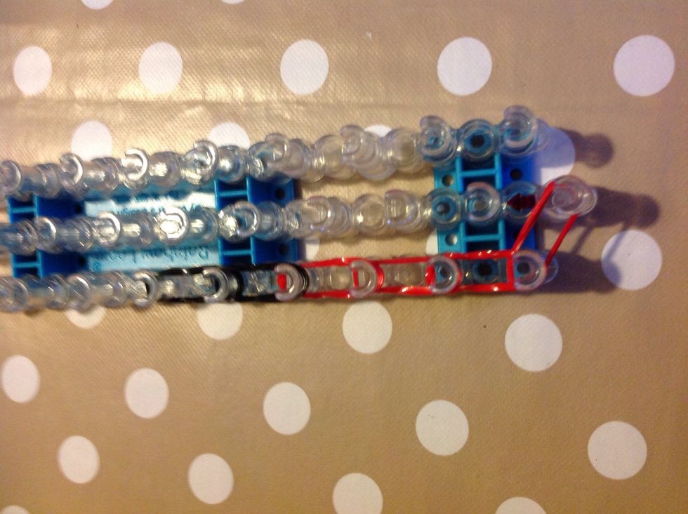 Lay six bands up the left side, making sure they are in doubles like on the last step. Then add four black bands up, making sure they are also double.