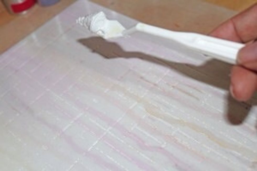 Lay stencil on inked canvas and apply molding paste with craft knife. I used the Sketch Grid  (TCW456) stencil.