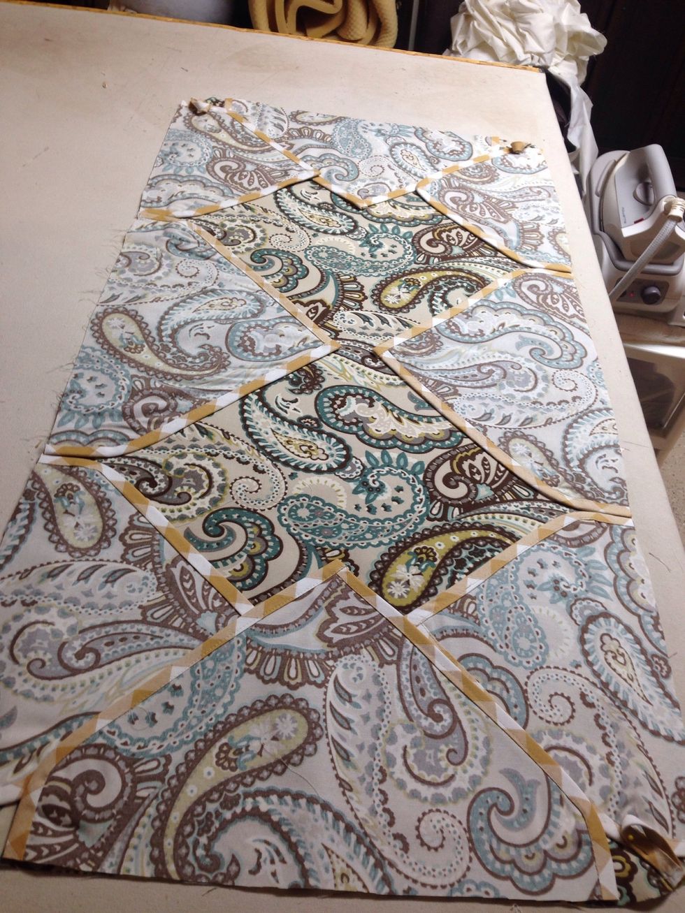 Lay Table Topper top out flat on table or work surface. Remove paper from Steam-A-Seam-II from points and lay face down on topper top as shown Do not remove paper on back side yet. Press in place