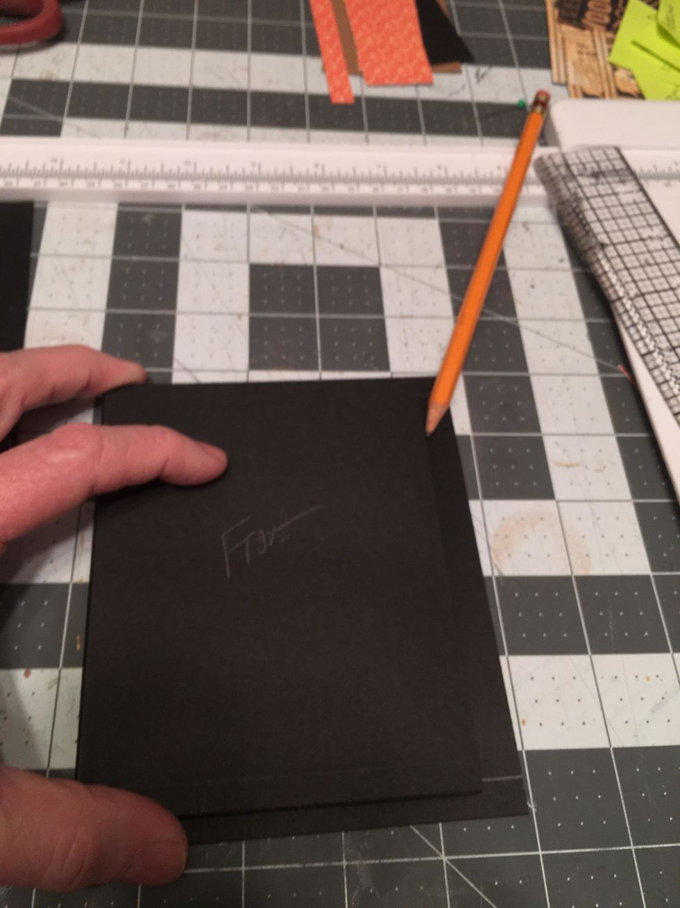 Lay the album pages onto one of the cover pieces with the left edge of the front side flush with the left edge of the cover piece. Use a pencil to draw a placement line on the right edge of the cover.