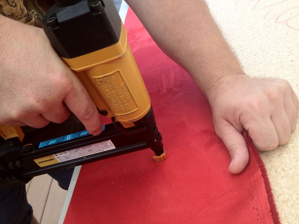 Lay the board foam-side down on the cloth you chose and begin pulling it over the back of the bard and securing it with the stapler.
