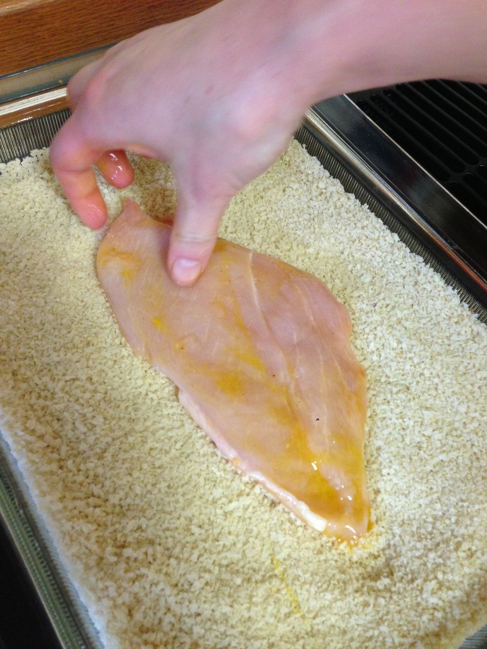Lay the chicken in the bread crumbs