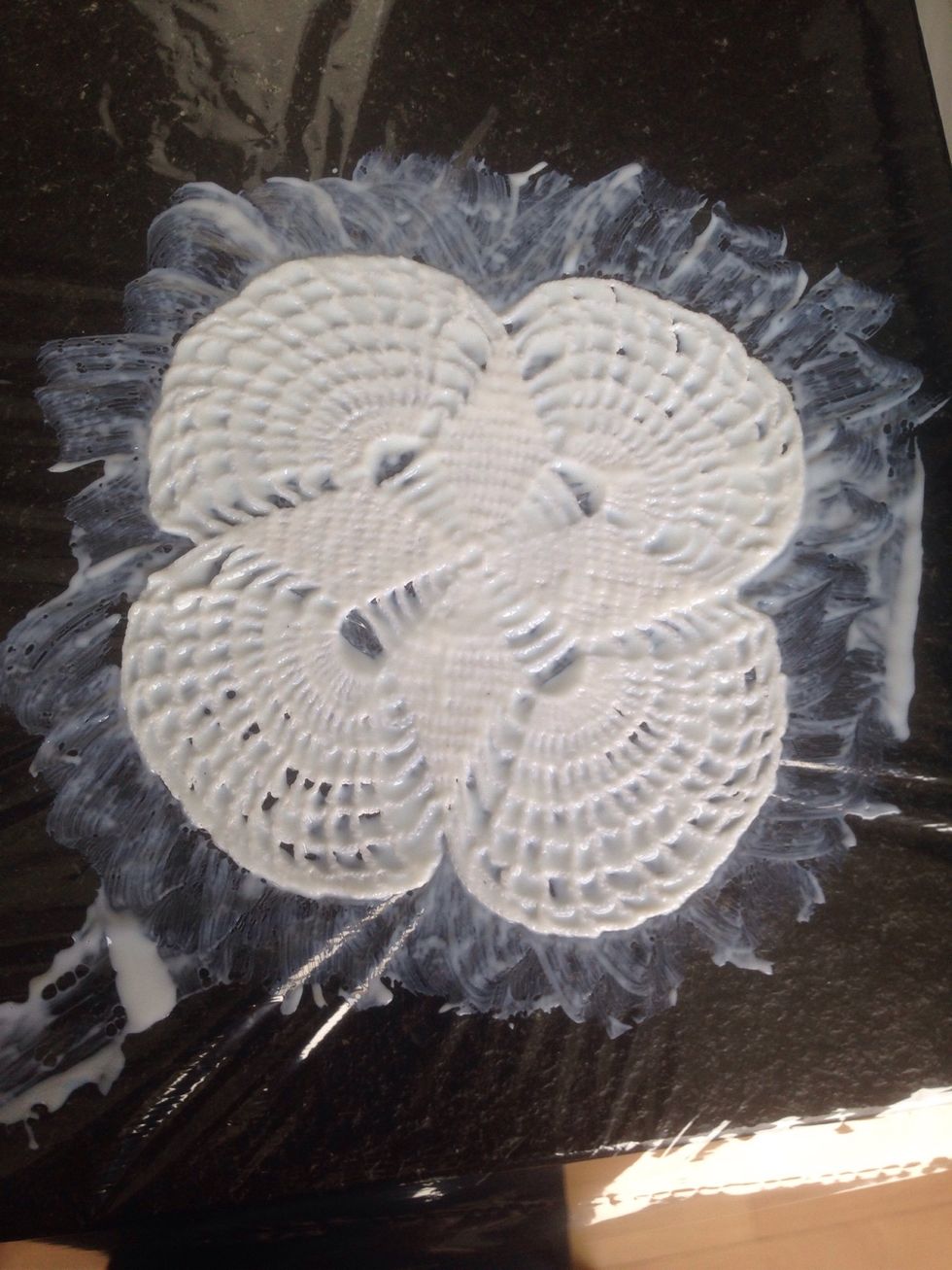 Lay the doily flat on the table and soak it in mod podge with a brush. Follow the shape of the lace so as not to mess up the fine pattern