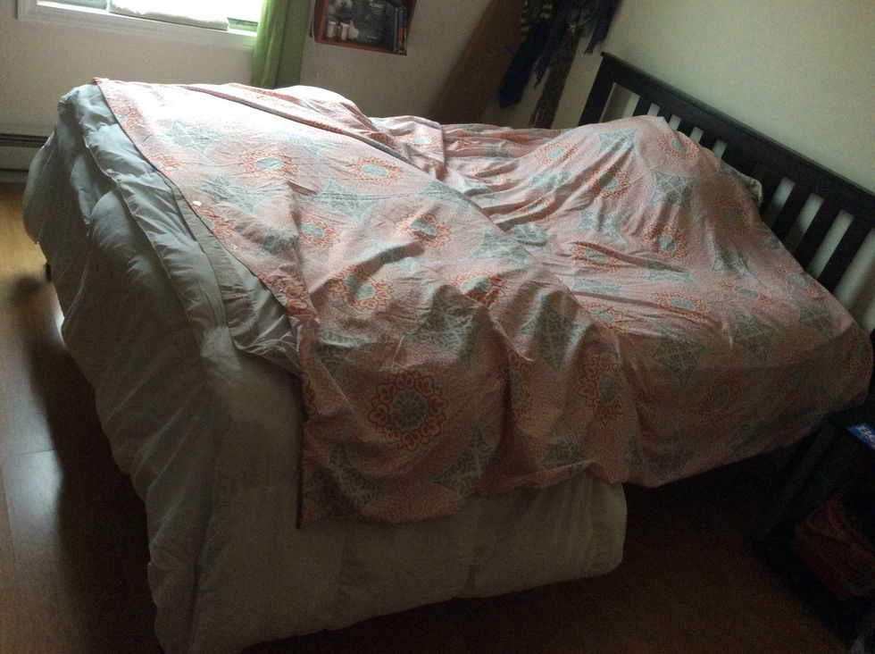 Lay the duvet cover on the bed as it will be in the end, with the buttons at the foot of the bed