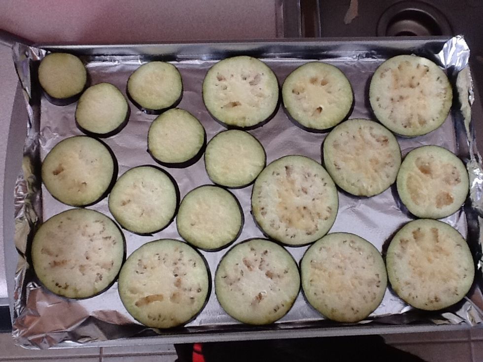 Lay the eggplant out on a foil lined cookie sheet. Brush olive oil on top, then place in the oven on broil for 3-5 mins or a little brown. Then flip the eggplant over, add more olive oil and repeat.