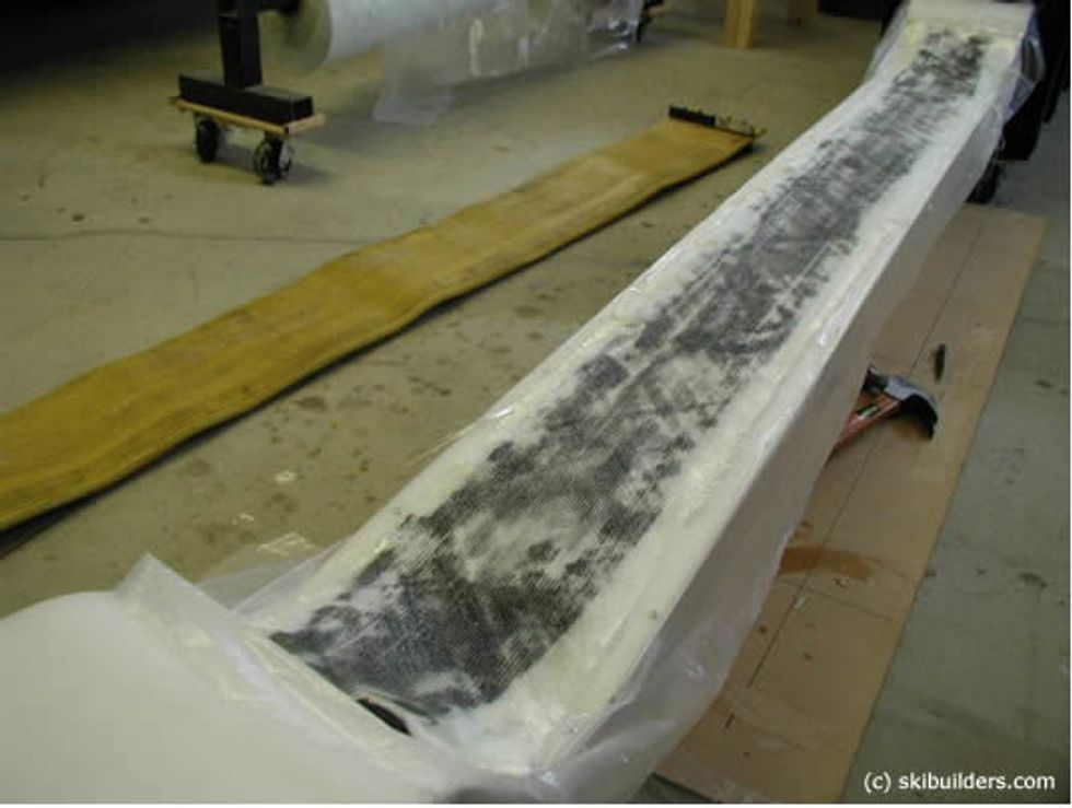 Lay the fiberglass over the rubber dampening strips and coat with epoxy