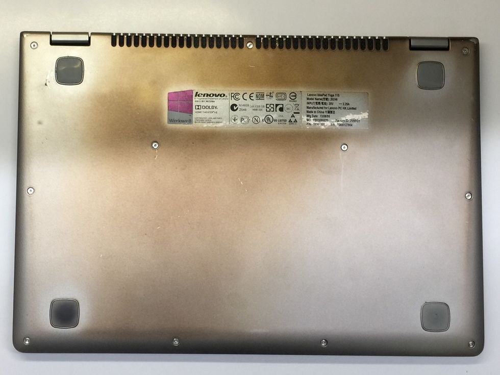 Lay the laptop, lid down on a stable, flat surface with the bottom facing up.