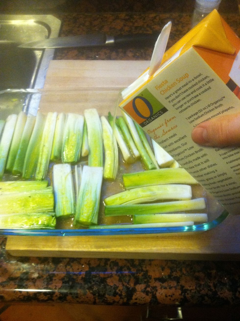 Lay the leeks out cut side up in an ovenproof casserole dish. Choose your dish size so you get a single layer, packed in pretty well. Add stock until leeks are 3/4ths submerged.