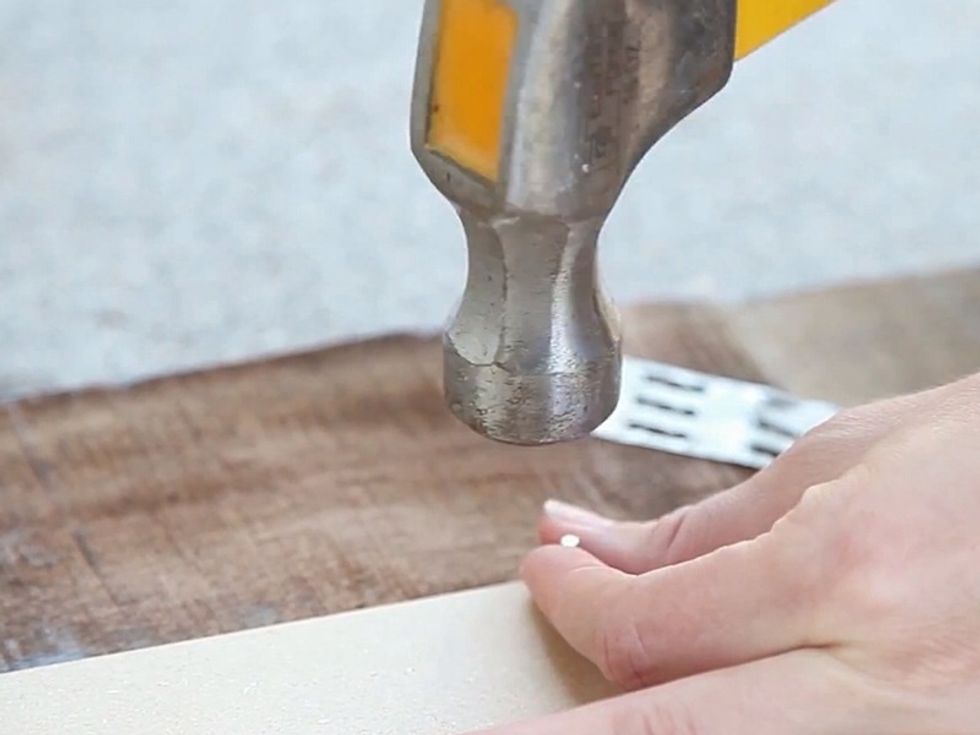 Lay the Masonite down and nail it to your frame.