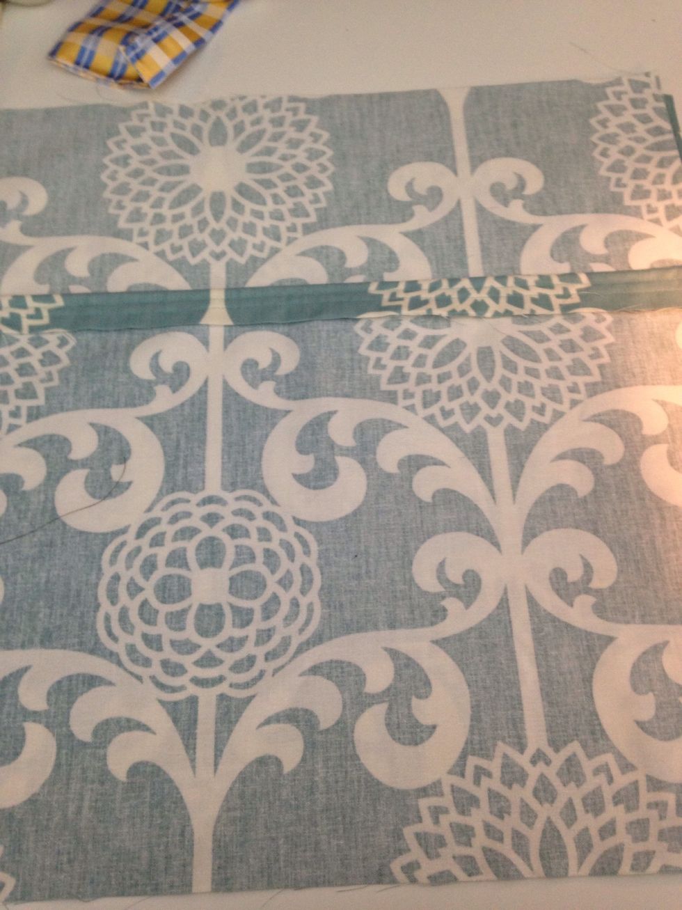 Lay the other hemmed piece on top, hemmed side to the center.