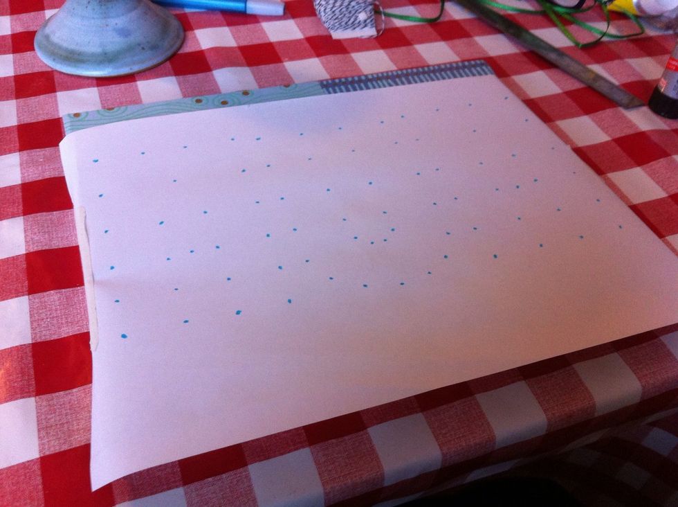 Lay the paper over the wood in the place you want the letters to be. Secure the paper with some tape.