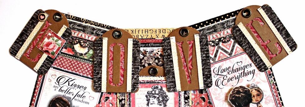 Lay the prepared envelops in a small arch shape. Adhere the prepared decorated letters to top of banner. Make sure when you do the "O" and "V" you allow yourself away to pull the hidden tag out.