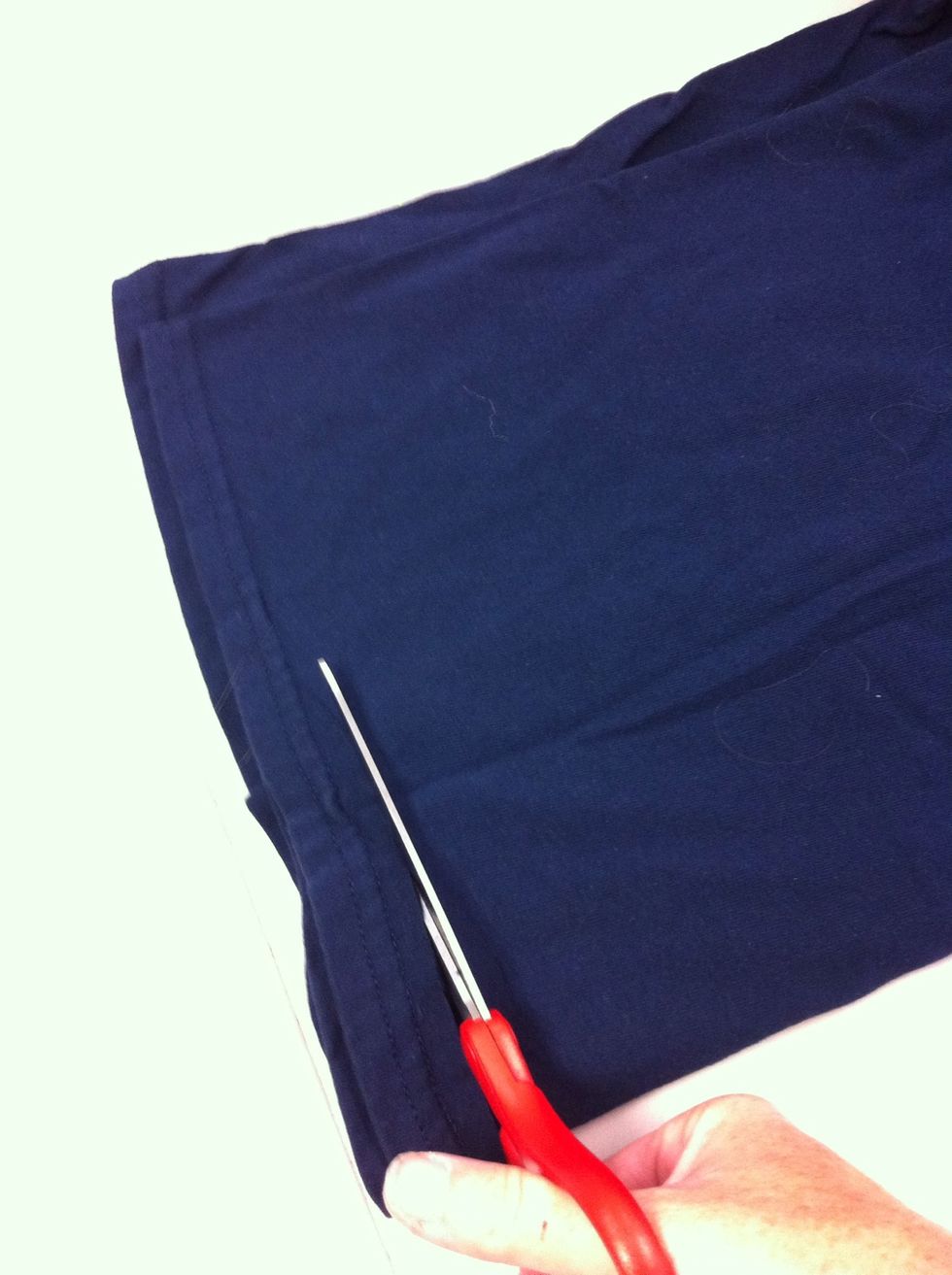 Lay the shirt flat and fold in half. Cut off the seam. You will not use the seams or the neck band.