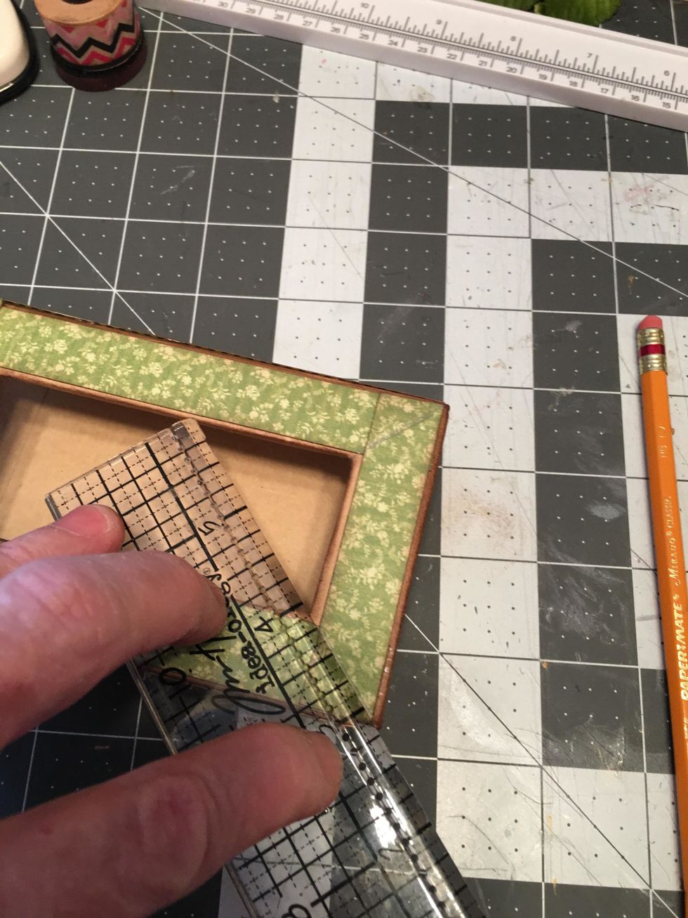 Lay the short pieces on the box (do not glue yet) and make an angle mark with your ruler & pencil and cut along the lines. Do this on each end of both paper pieces.