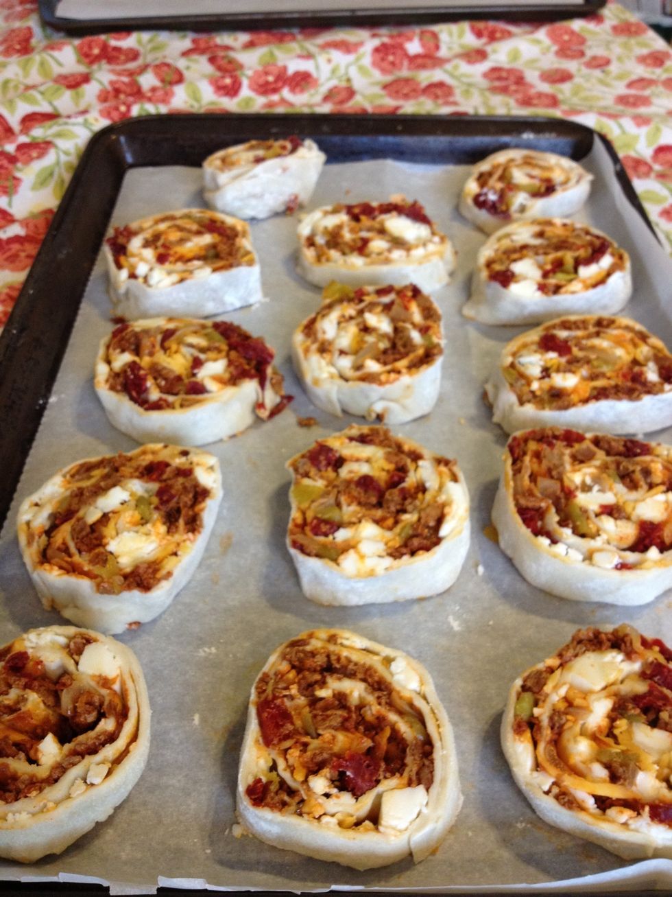 ...lay the slices out on a cookie sheet lined with parchment paper. Then into the oven they go for about 15 minutes - they're done when the pastry is golden brown and the cheese has melted.