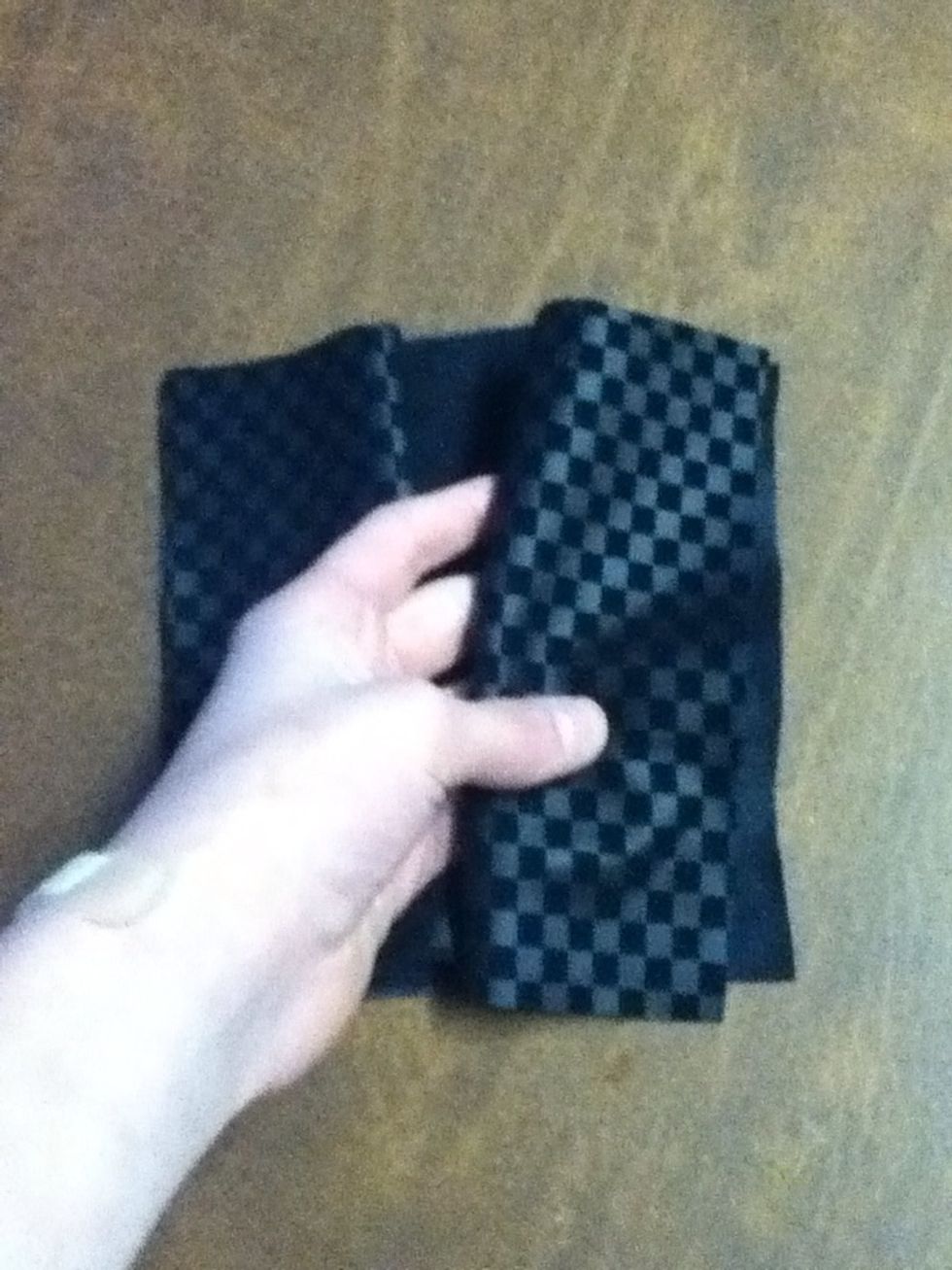 Lay the smaller fabric face up. Take the two folded rectangles and lay them on top.