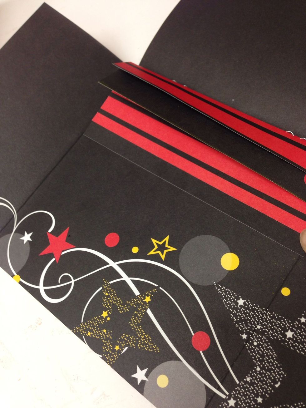 Lay the spine in place on the back cover and test to make sure it fits when the flaps are closed. Trim the edges if necessary. Adhere the back side of the spine to the back cover of your album.