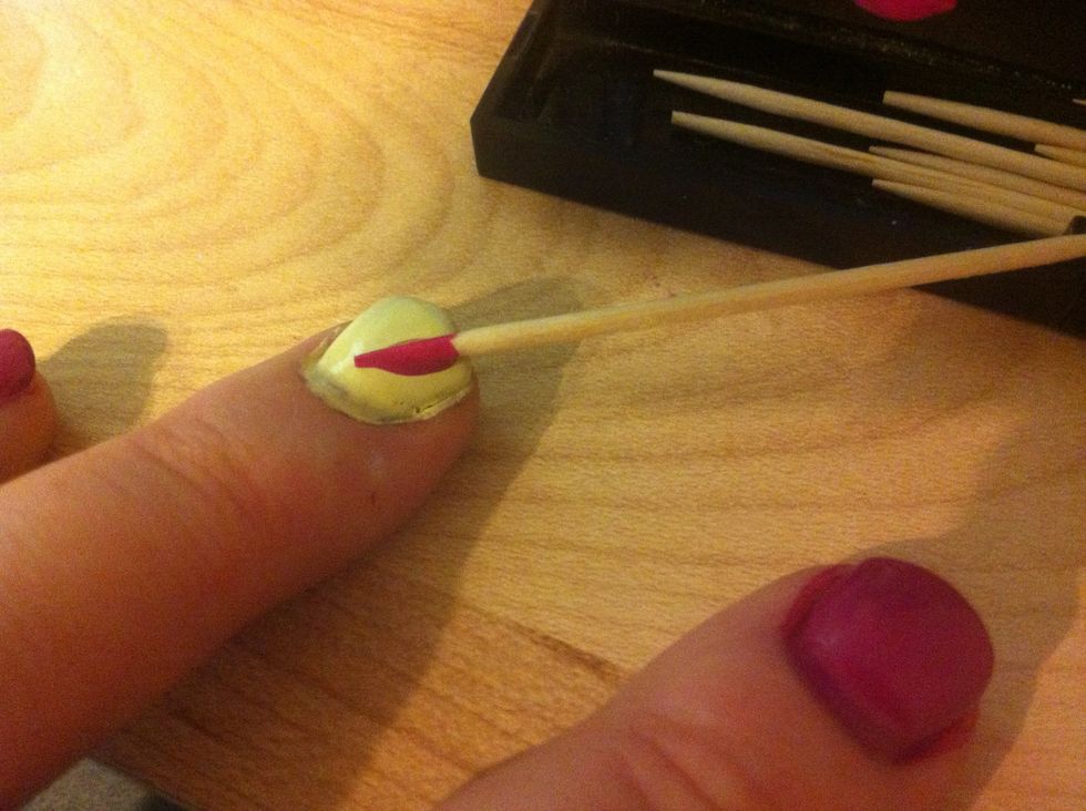 Lay the toothpick on your nail at angle. This is one side of the heart. LAY FLAT! Don't deposit a drop then drag - that makes uneven edges.