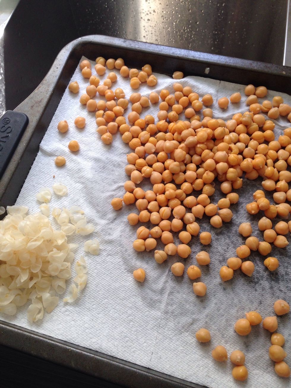Lay them on a paper toweled baking sheet &cover with another paper towel and gently move the paper towel around to dry them off. The skins will start to come off. Peel the remaining ones that don't.