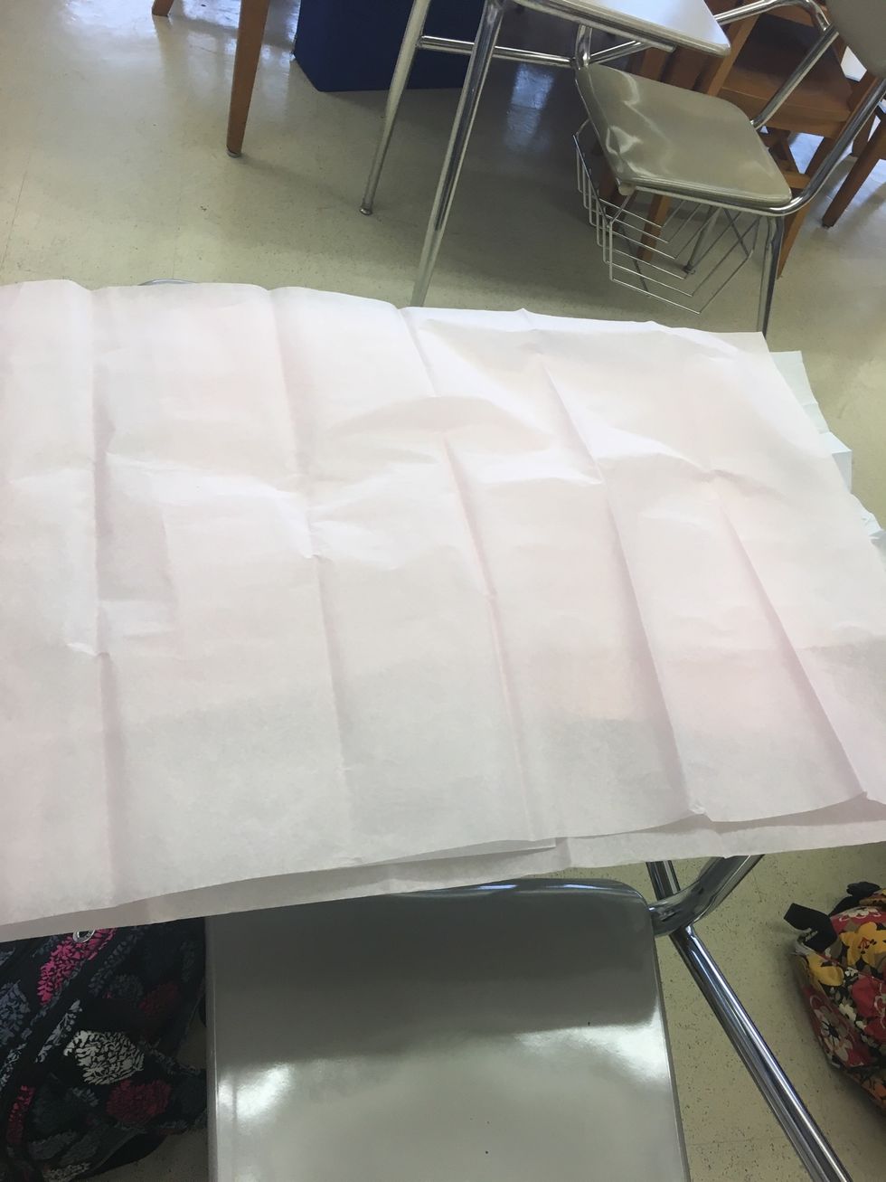 Lay three sheets of unfolded tissue paper stacked on top of each other