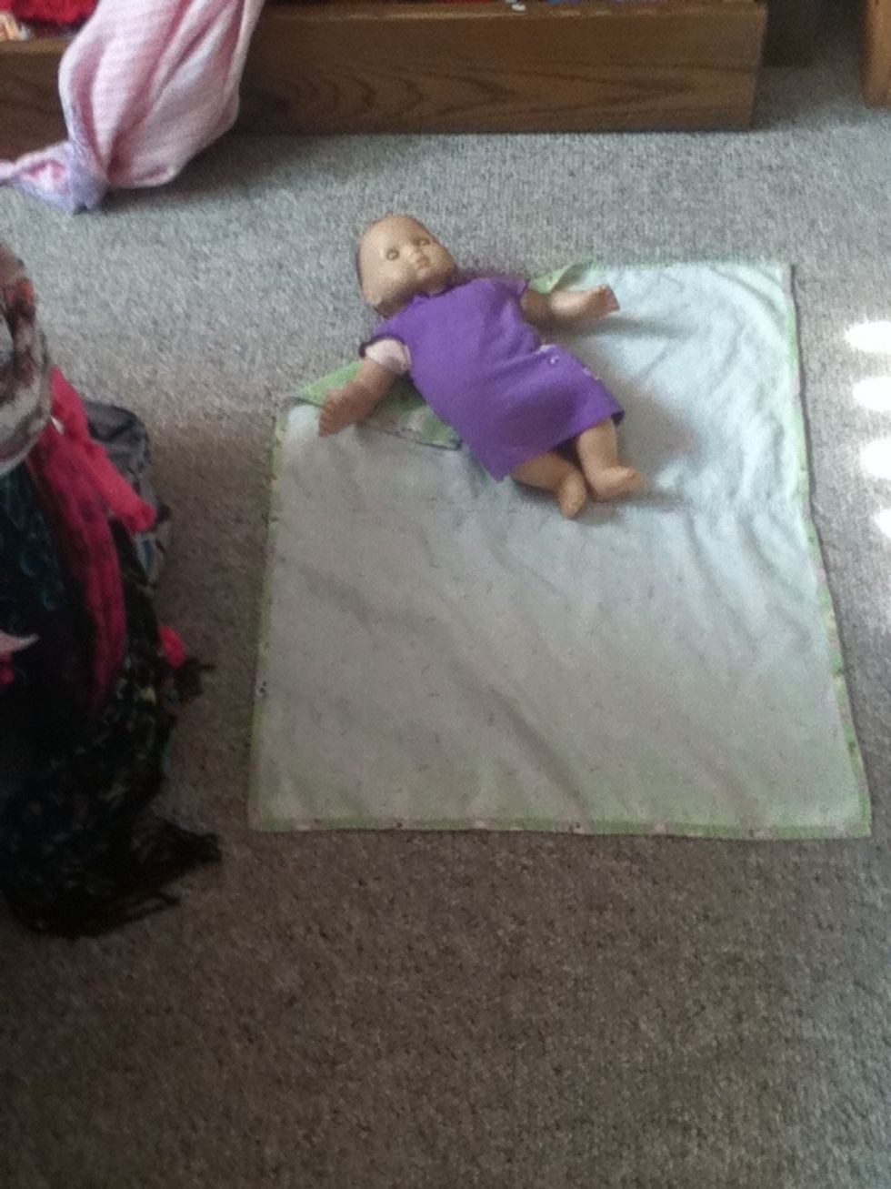 Lay your baby down on the corner that you folded in (i used a baby doll).
