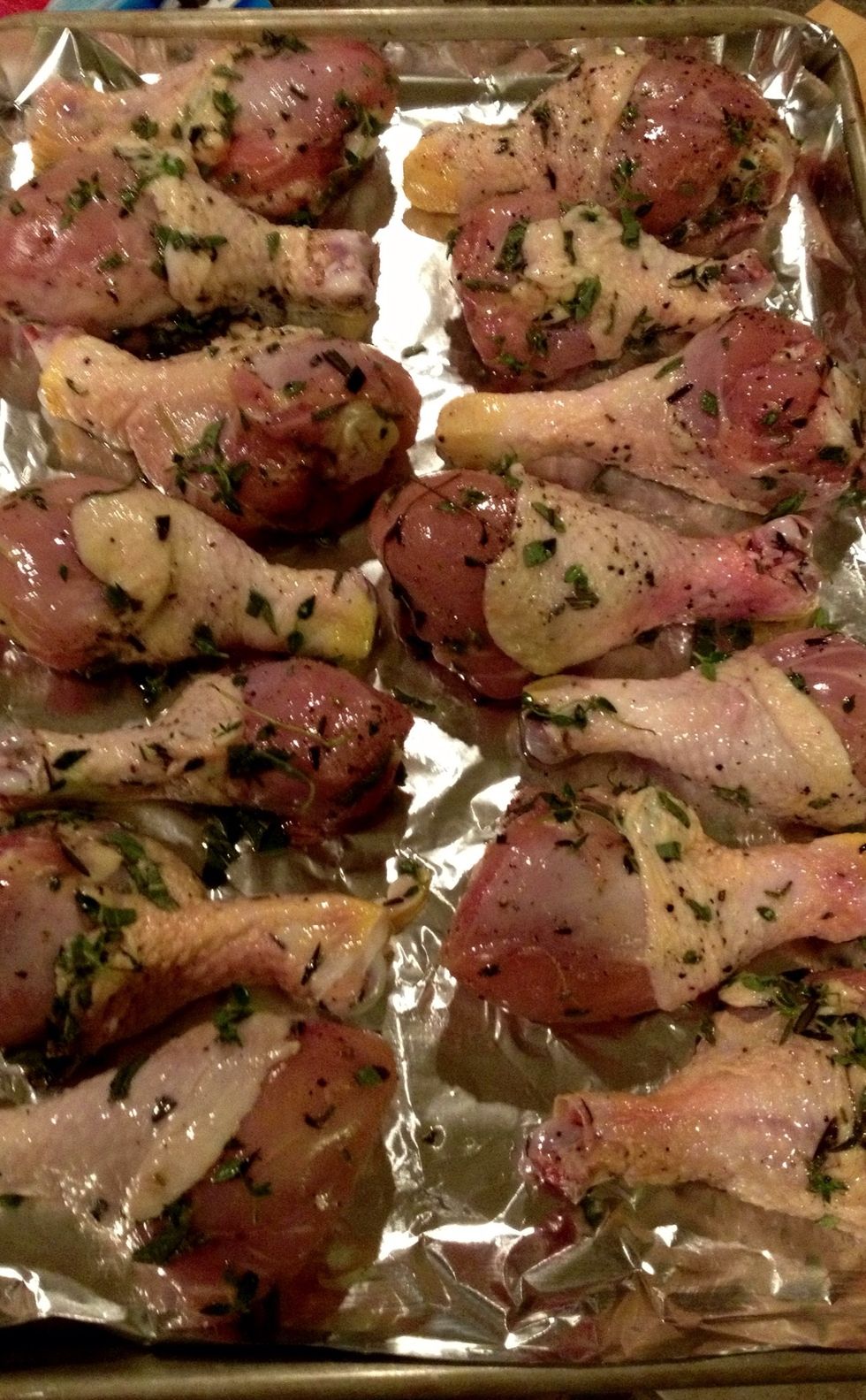 Lay your beautifully herbed chicken pieces out on a baking sheet. I put down foil to make cleanup a little easier. If you prefer hard labor cleanup, by all means skip that part.