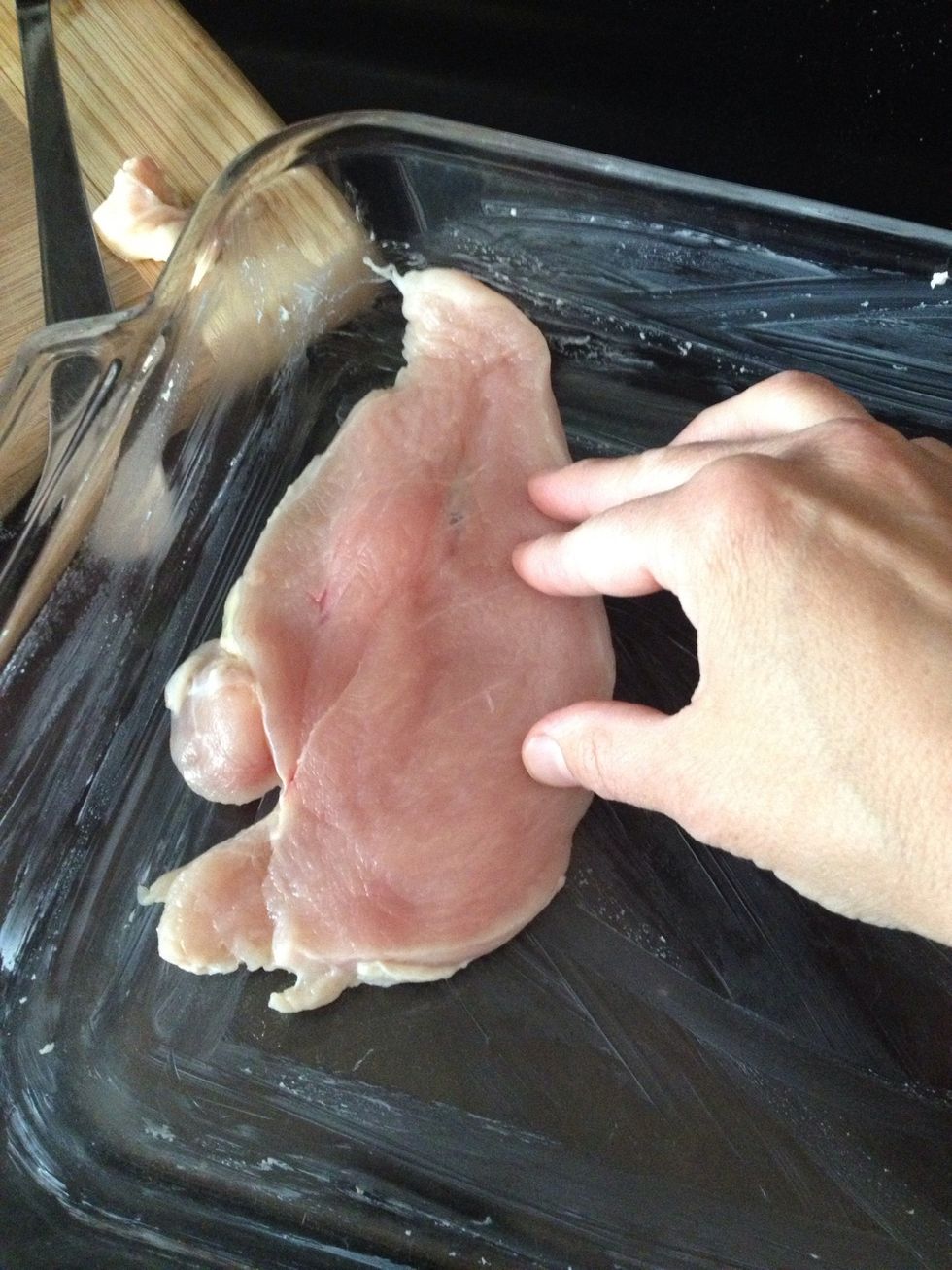 Lay your chicken piece into the dish.