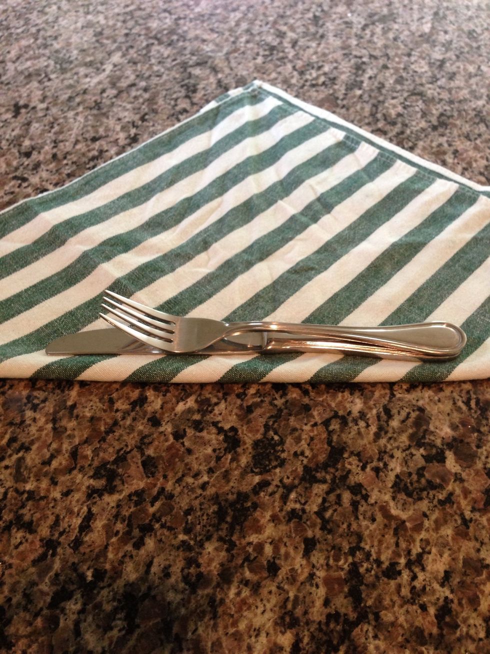 Lay your fork, tines up, on top of the knife. It's ok, they're married.